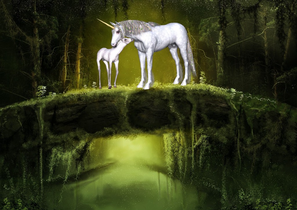 A unicorn and a foal stand on a tree bridge in a forest