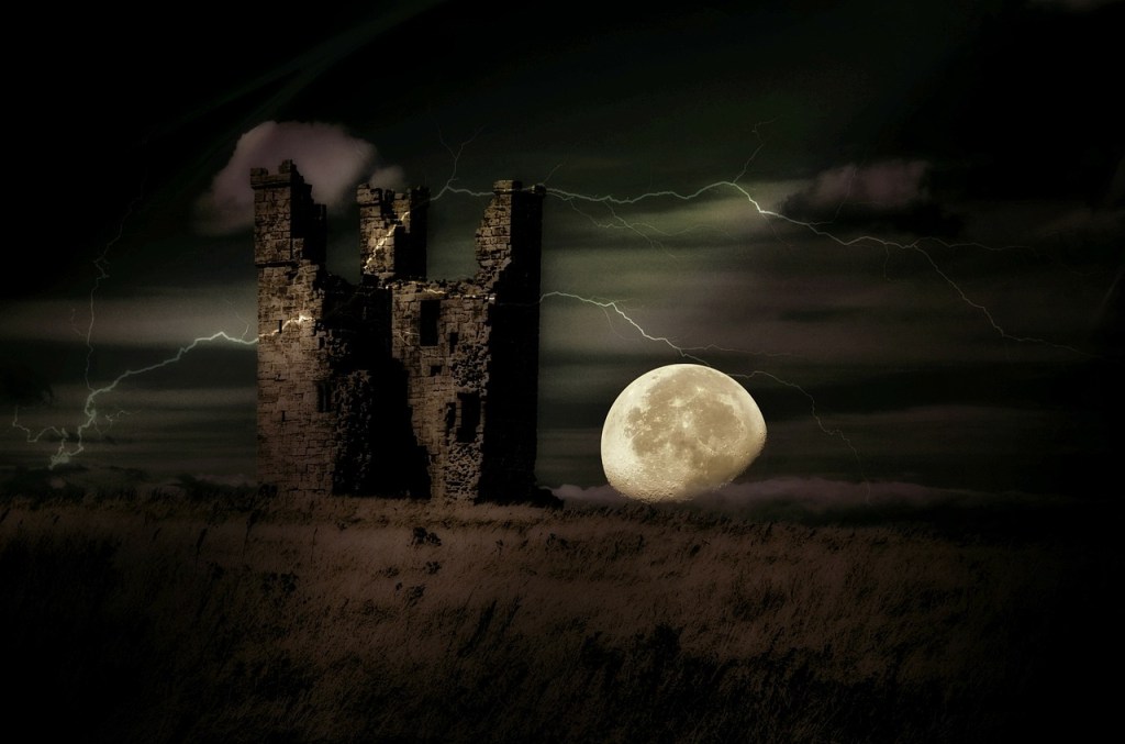 A ruined castle with a night sky and full moon behind
