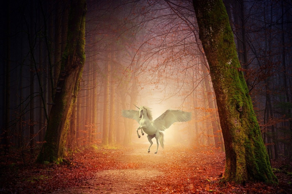 A white winged unicorn on its hindlegs in a forest glade